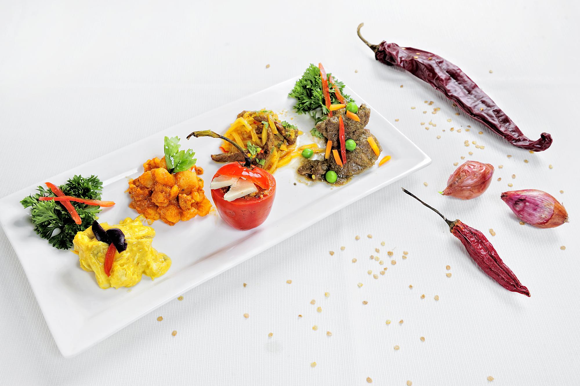 Selection of plated courses on wooden table